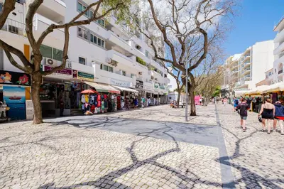 a street in a city with people walking down the street at Old Town Soul in Albufeira