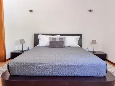 a bedroom with a large bed with two night stands at Silver Globe in Albufeira
