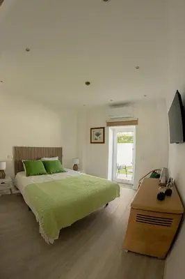 a bedroom with a bed with red pillows on it at Quinta da Pi Silveira in Loulé