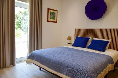 a blue tiled bathroom with a tub and a toilet at Quinta da Pi Silveira in Loulé