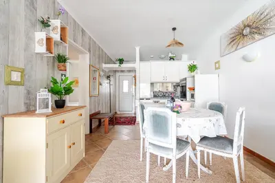 a kitchen and dining room with a table and chairs at Maison Du Soleil by Seareen in Albufeira