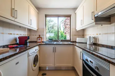 a kitchen with a sink and a dishwasher at Apartamento Sol & Mar by Portucasa in Albufeira