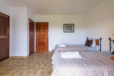 a hotel room with two beds and a door at Apartamento Sol & Mar by Portucasa in Albufeira