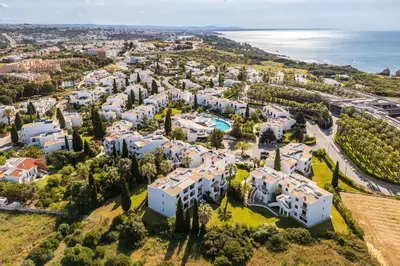 an aerial view of a villa with trees and buildings at Apartamento Sol & Mar by Portucasa in Albufeira