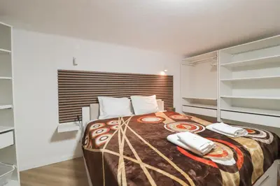 a bedroom with a bed with two phones on it at Solar do Golf T1 Vilamoura Old Village in Quarteira