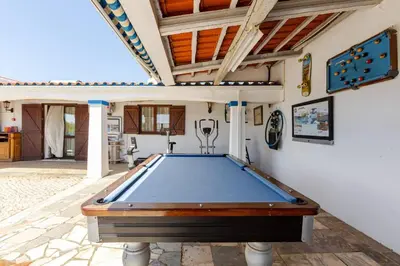 a pool table in the middle of a room at Maison A Quinta V1 4 Personnes in Ferreiras