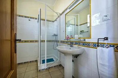 a bathroom with a sink and a shower at Rebela 1st Algarve Villa Holidays in Albufeira