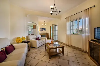 a living room with a couch and a table at Rebela GF by Algarve Villa Holidays in Albufeira