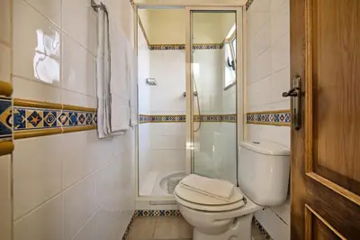 a small bathroom with a toilet and a shower at Rebela GF by Algarve Villa Holidays in Albufeira