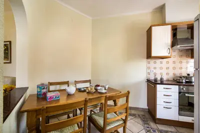 a kitchen with a wooden table and chairs at Rebela GF by Algarve Villa Holidays in Albufeira