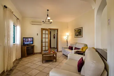 a living room with a couch and a tv at Rebela GF by Algarve Villa Holidays in Albufeira