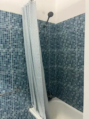 a bathroom with a shower with blue tiles at Amazing Sea View Studio w Pool in Albufeira