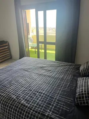 a bed with a black and white comforter in a bedroom at Amazing Sea View Studio w Pool in Albufeira
