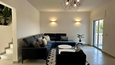 a living room with a blue couch and a table at Cruzeiro by Check-in Portugal in Quarteira