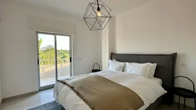 a bedroom with a large bed and a window at Cruzeiro by Check-in Portugal in Quarteira
