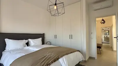 a bedroom with a bed and a chandelier at Cruzeiro by Check-in Portugal in Quarteira