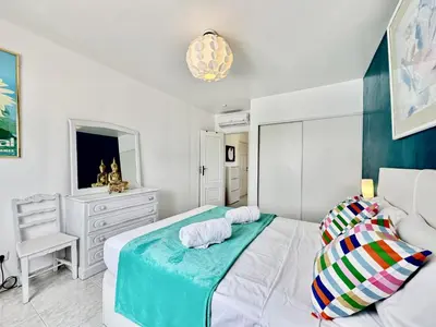 a white living room with a table and a fireplace at Albufeira Tropical View 2 by Homing in Sesmarias
