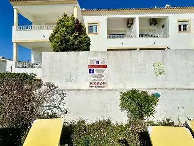 a building with a sign on the side of a wall at Albufeira Tropical View 2 by Homing in Sesmarias