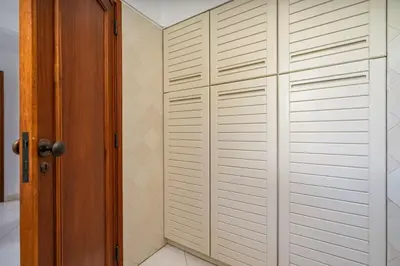 a closet with white closet doors in a room at Sunny Flat with a Balcony & Pool by HostWise in Albufeira