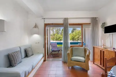 a living room with a couch and a chair at Santiago’s Oura House in Albufeira
