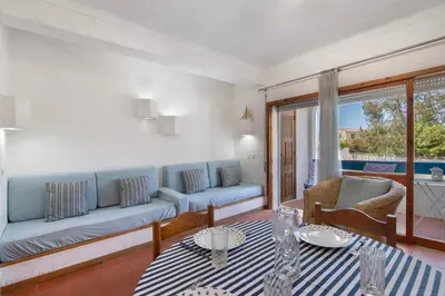 two chairs and a table on a balcony at Santiago’s Oura House in Albufeira