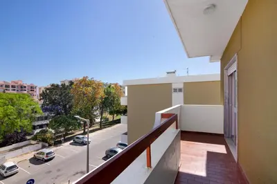 a balcony of a building with a view of a street at Justo's House in Faro