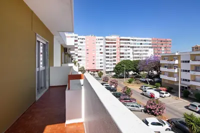 a balcony with a view of a parking lot at Justo's House in Faro
