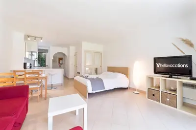 a kitchen with white cabinets and a washer and dryer at Apt 77 - São Rafael by HelloVacations in Albufeira
