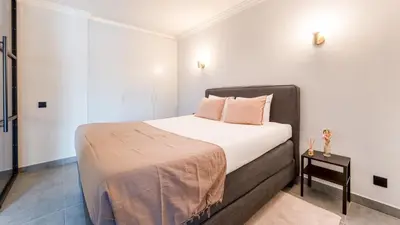a small bedroom with a bed and a table at Modern Studio with Balcony in Salgados by Lovelystay in Guia