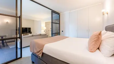 a bedroom with a bed and a living room at Modern Studio with Balcony in Salgados by Lovelystay in Guia