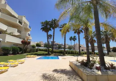 a resort with a swimming pool and palm trees at São rafael Ocean View in Albufeira