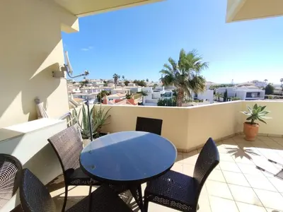 a table and chairs on a balcony with a view at São rafael Ocean View in Albufeira