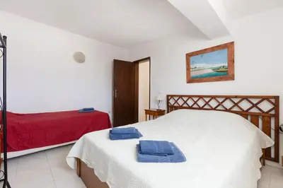 a bedroom with a bed with two towels on it at Maison A Quinta V2A 5 Personnes in Ferreiras