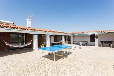 a ping pong table on the patio of a house at Maison A Quinta V2B 7 Personnes in Ferreiras