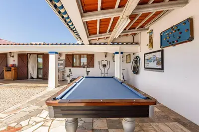 a pool table in the middle of a patio at Maison A Quinta V2B 7 Personnes in Ferreiras