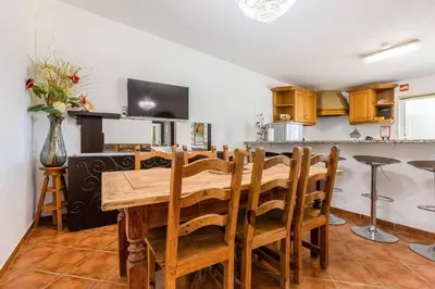 a kitchen and dining room with a wooden table and chairs at Maison A Quinta V2B 7 Personnes in Ferreiras