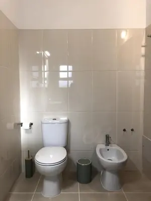 a bathroom with a toilet and a sink at Apt H - Beach Village in Olhos de Água