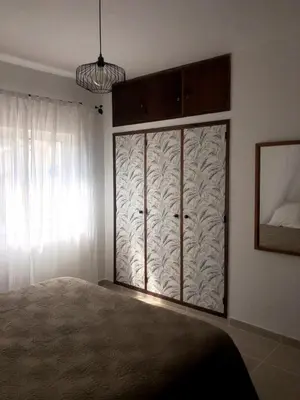 a living room with a couch and a table at Apt H - Beach Village in Olhos de Água