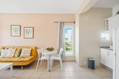 a living room with a couch and a table at Stork nest in Vilamoura