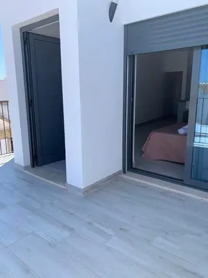 a room with two sliding glass doors and a bed at Casa Susana in Faro