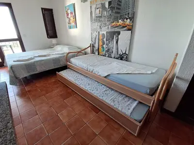 two bunk beds in a room with a tile floor at T0 close to the beach and the city center in Albufeira