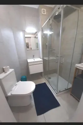 a bathroom with a shower and a toilet and a sink at T0 close to the beach and the city center in Albufeira
