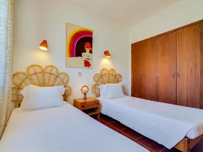 two beds sitting next to each other in a room at Apartamento Forte Novo no centro de Quarteira in Quarteira