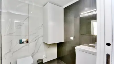 a white bathroom with a sink and a toilet at Monte Verde A,Lar Linda - CD 293 Cleverdetails, Sleeps 2 adults and 2 children, 4 salted water pools in Quarteira