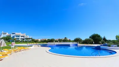 a large swimming pool with lounge chairs at Monte Verde A,Lar Linda - CD 293 Cleverdetails, Sleeps 2 adults and 2 children, 4 salted water pools in Quarteira