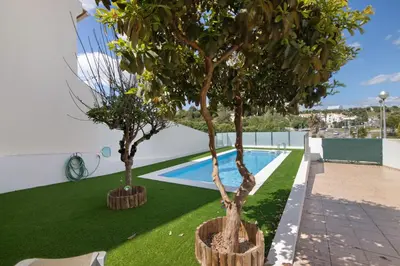 a swimming pool in the backyard of a villa at Villa Neves in Albufeira