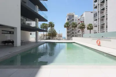 a swimming pool in the middle of a building at Terracos de Quarteira Orange by Real Properties in Quarteira