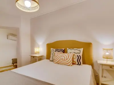 a bedroom with a white bed with two lamps at AL Vilamoura Porto Marina in Vilamoura