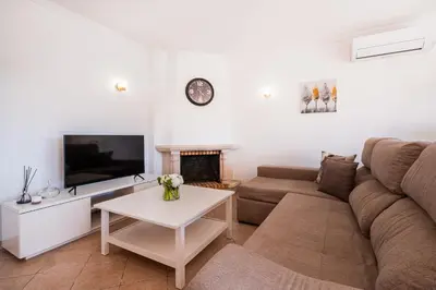 a living room with a couch and a fireplace at Villa Lamella in Albufeira