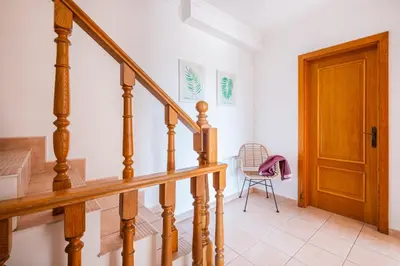 a staircase in a house with a wooden door at Villa Lamella in Albufeira